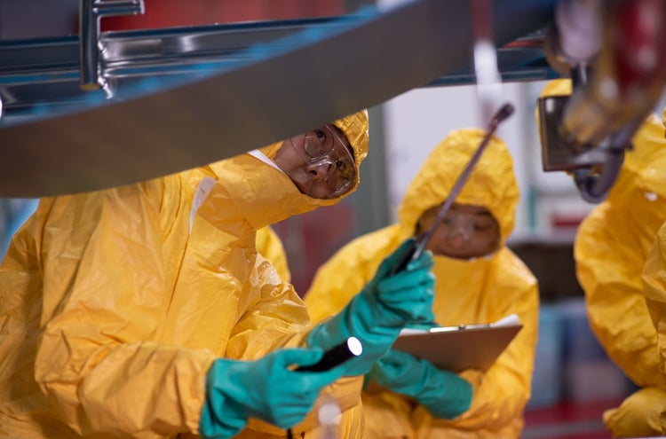 team inspecting conveyor system