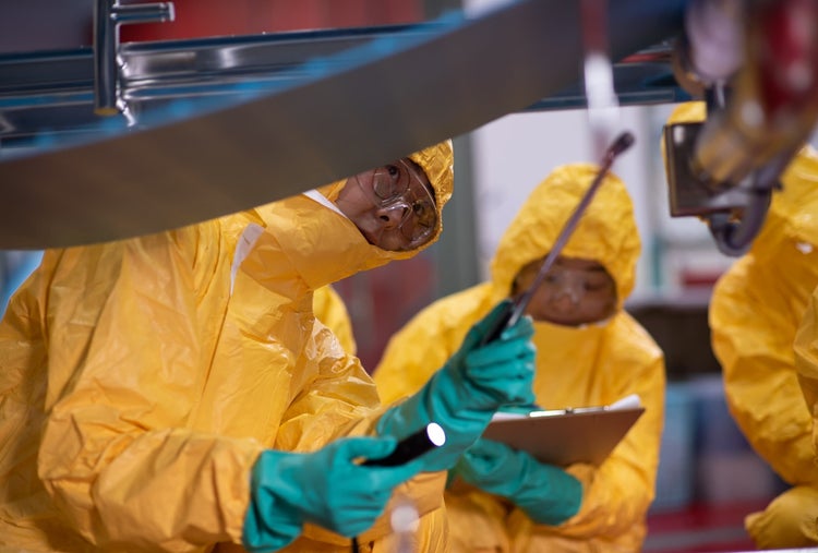 team inspecting conveyor system