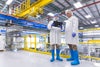 2 people collaborating on mezzanine of food processing facility