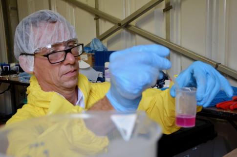 man with chemical beaker 