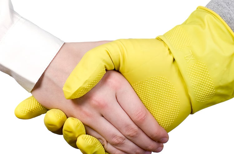 Two hands shaking, one in PPE