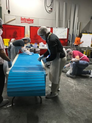 people inspecting conveyor belt