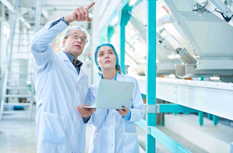 two people conducting conveyor examination