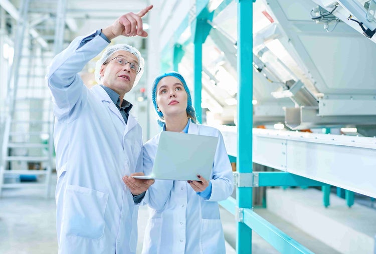 two people conducting conveyor examination