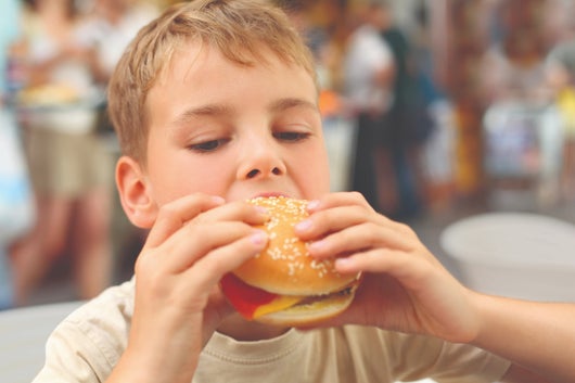 Boy eating hamburger