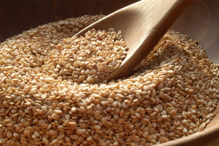 Pot and spoon with sesame seeds