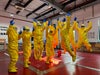 Participants in yellow PPE jumping in China Sanitation Essentials Training