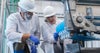 Two people inspecting a conveyor