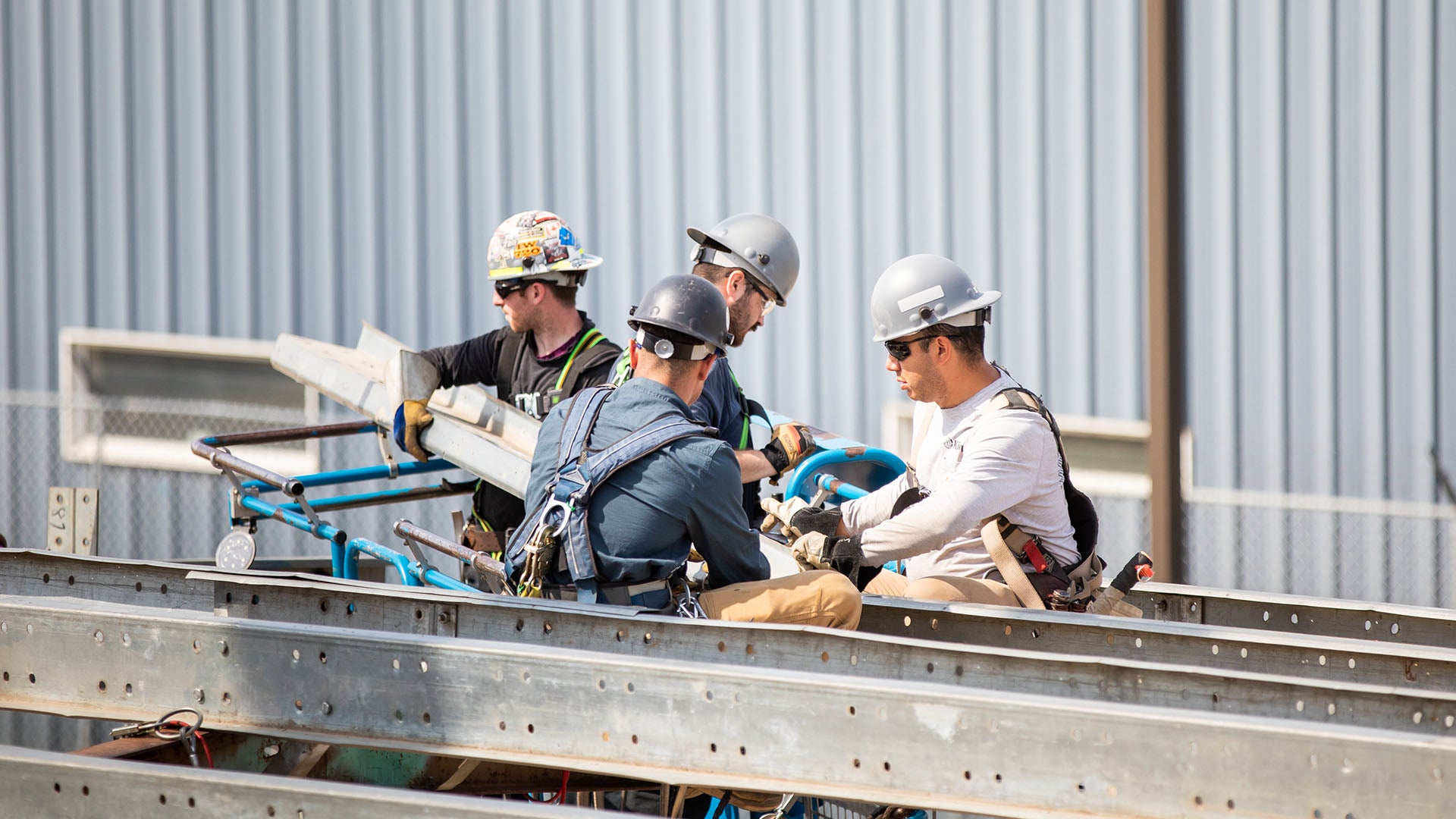 A group of 4 ironworkers on a jobsite. A group of 4 ironworkers on a jobsite.