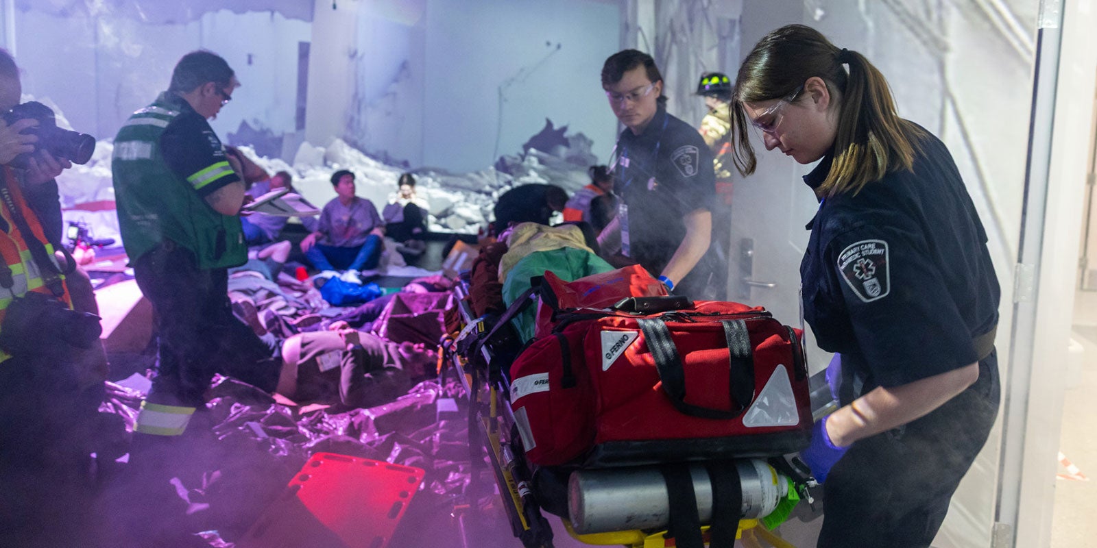 A group of people in a room with a stretcher A group of people in a room with a stretcher
