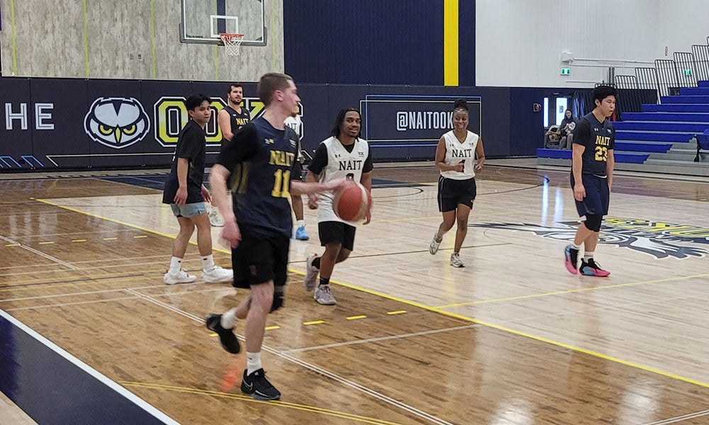 A group of people playing basketball