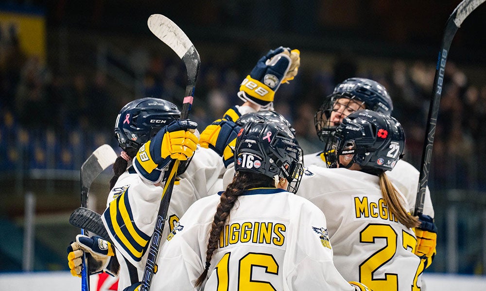 A group of women in hockey uniforms