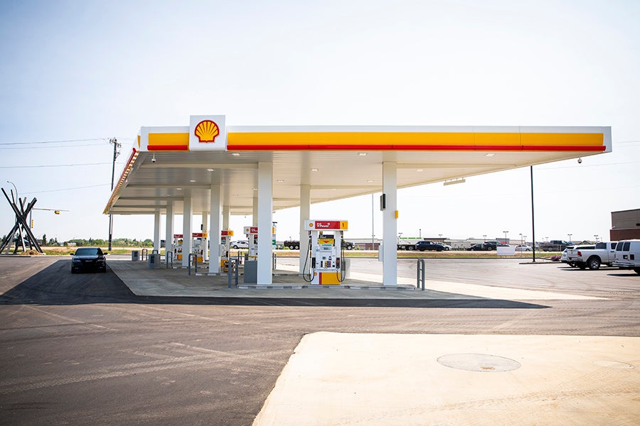A gas station with a yellow and red sign