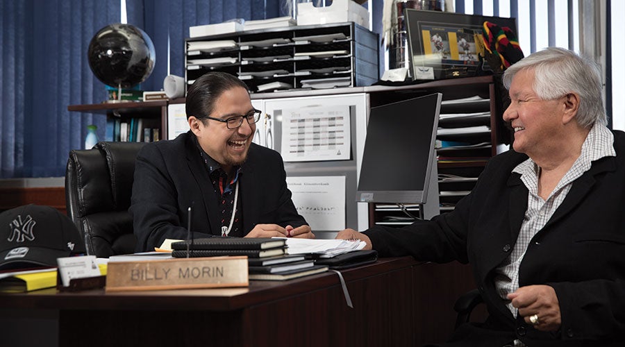 A man laughing at another man