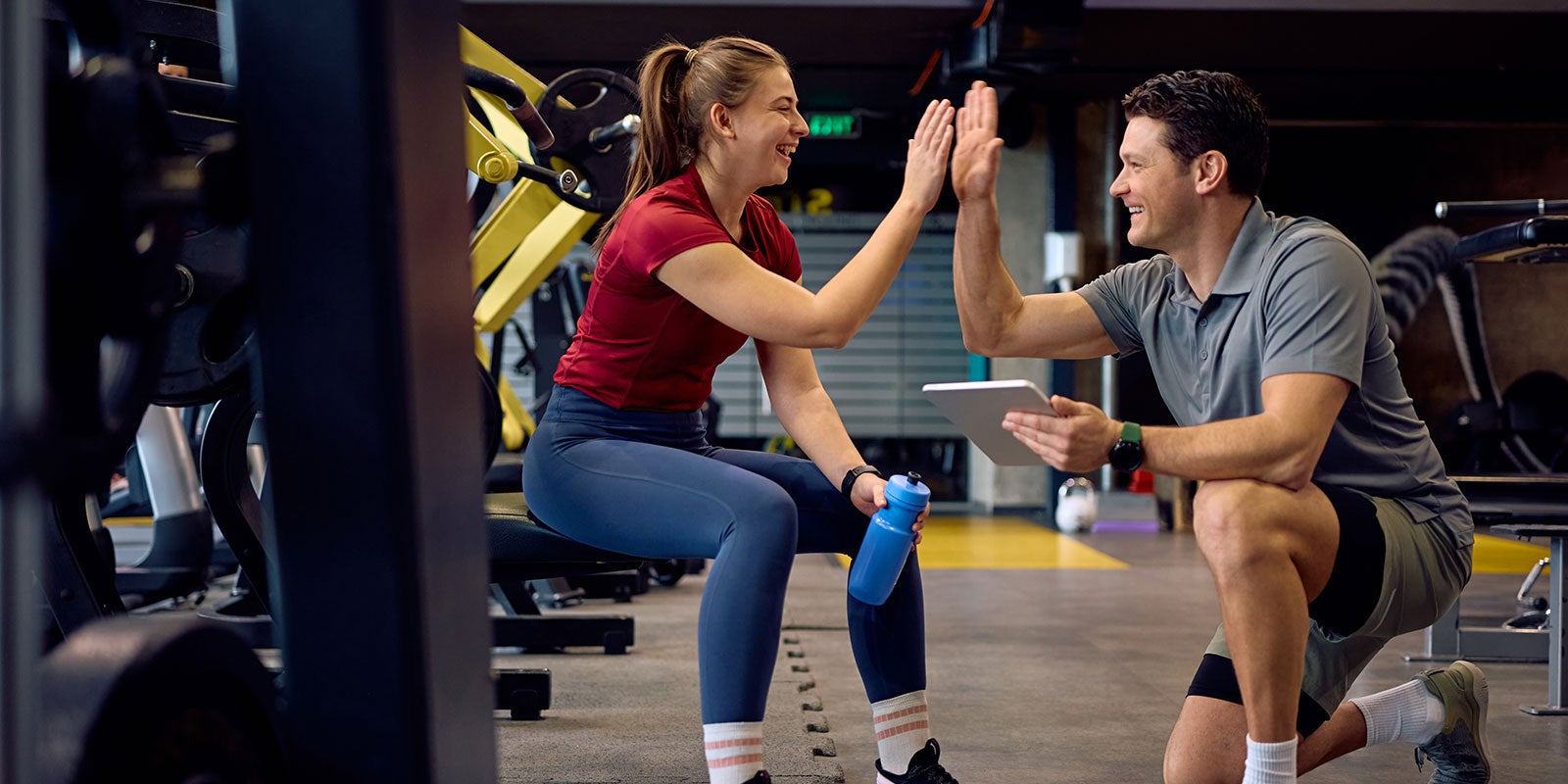 A man and woman giving each other a high five A man and woman giving each other a high five
