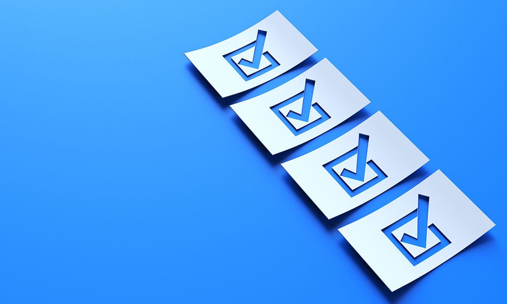 A row of papers with check marks