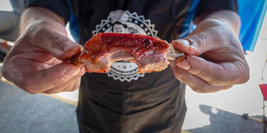 A person holding a piece of meat