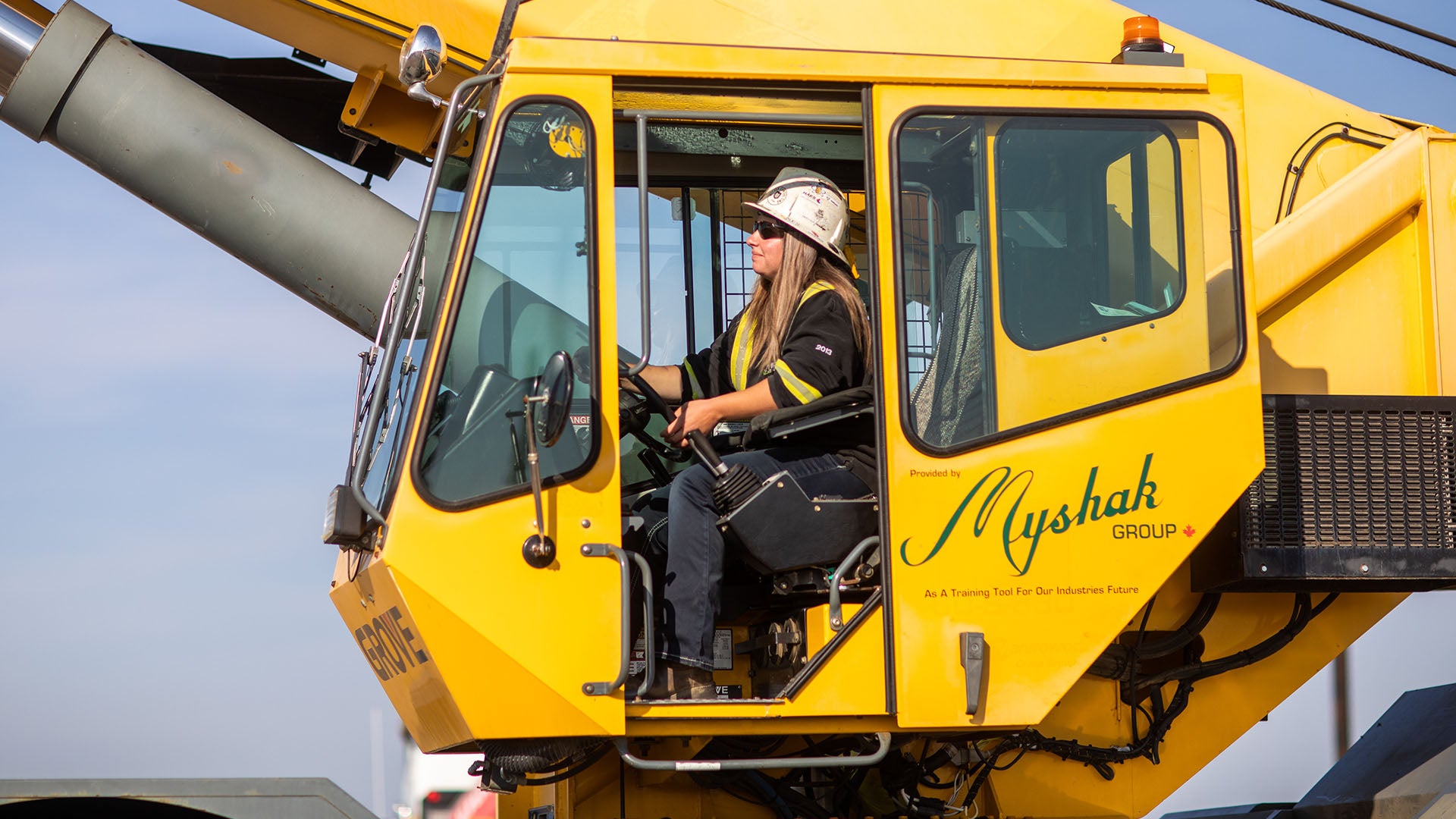 A female operating a rough terrain crane. A female operating a rough terrain crane.