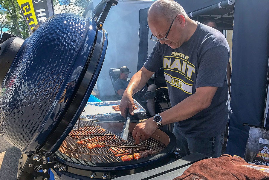 A man cooking food on a grill