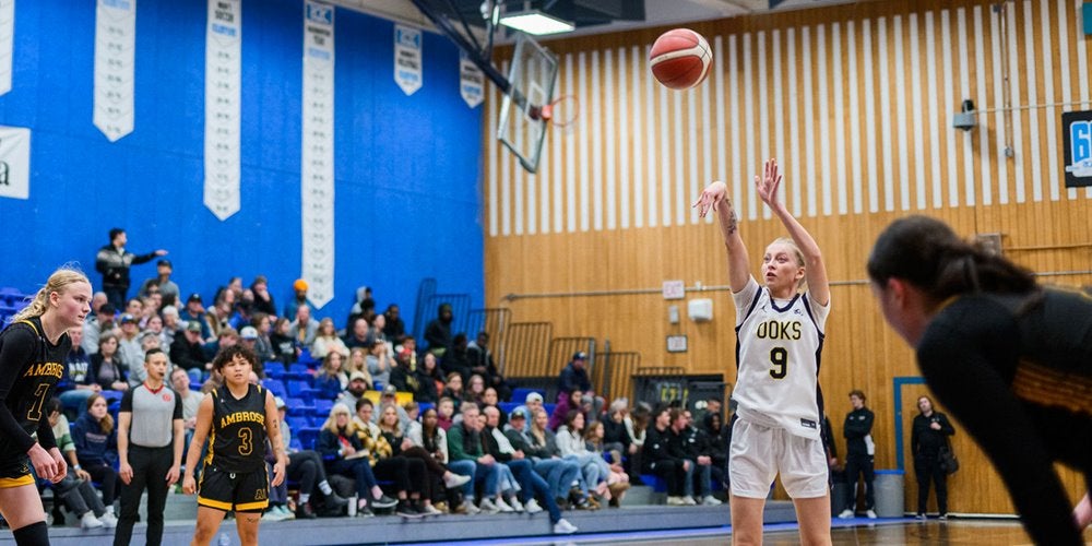 A woman playing basketball in a gym