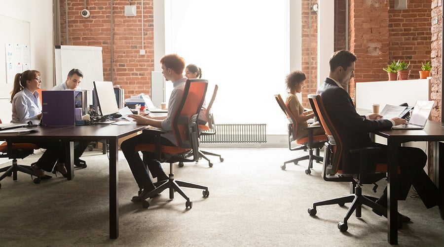 A group of people sitting at a desk