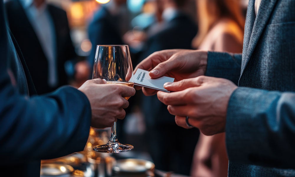A person holding a glass of wine
