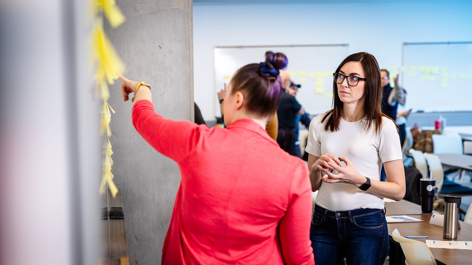 Two students planning organizational strategy on NAIT campus.