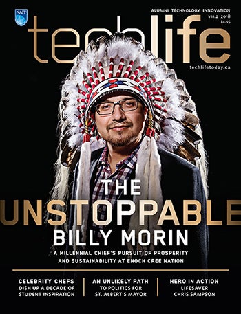 A man wearing a headdress and a black jacket