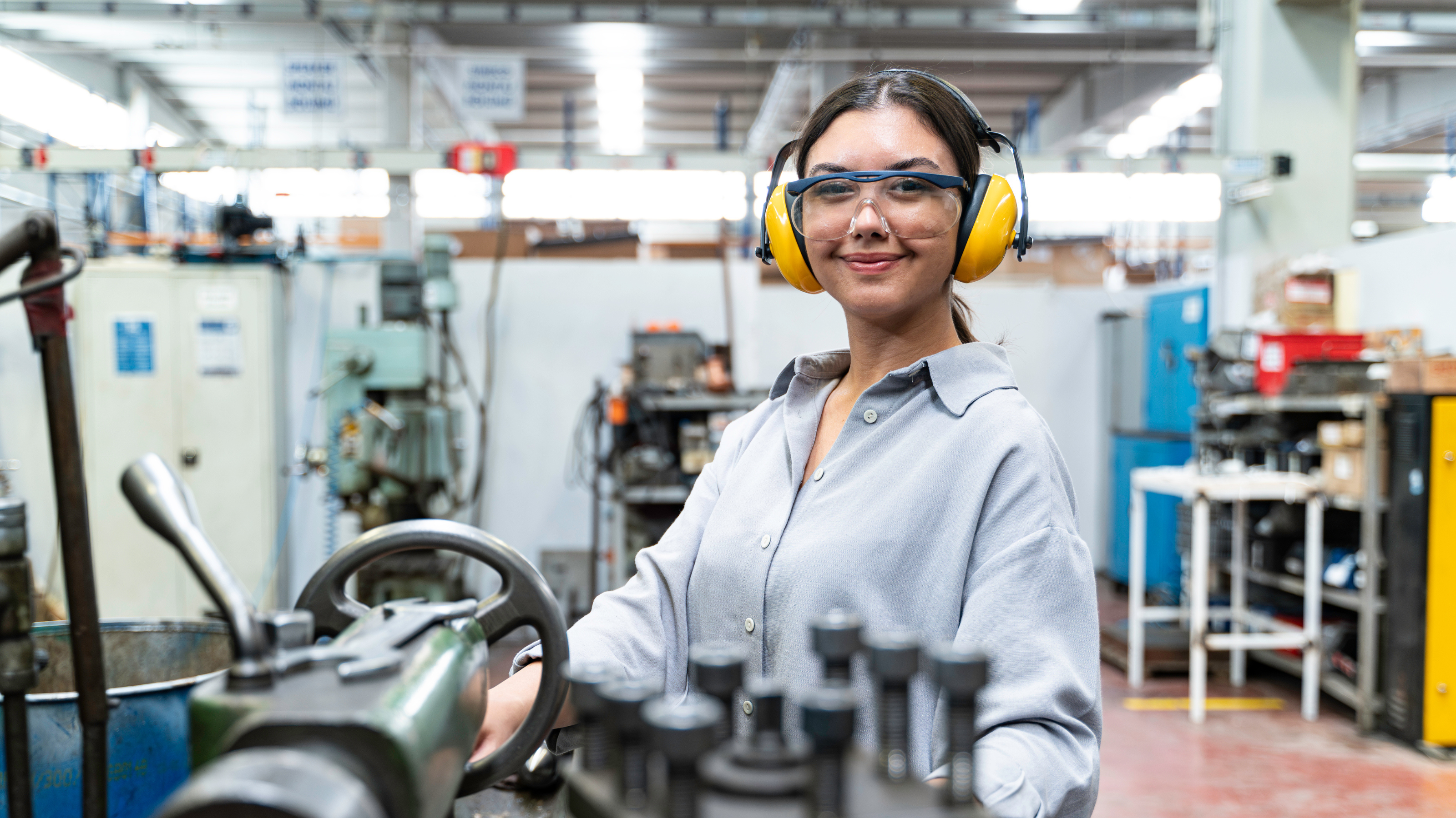 Woman in engineering factory smiling