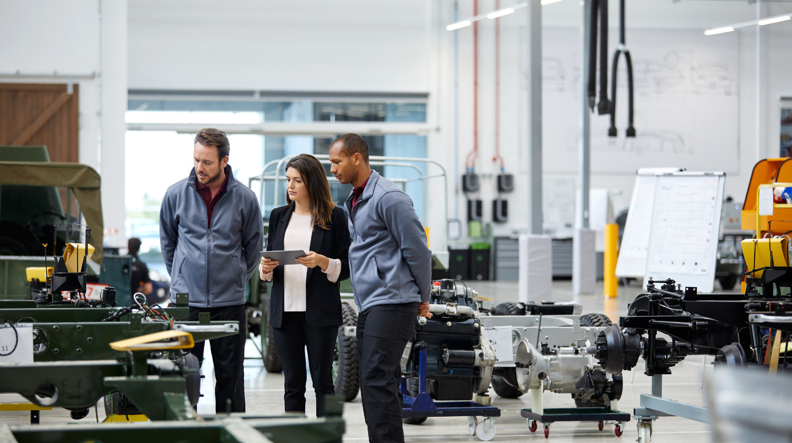 Three engineers in factory