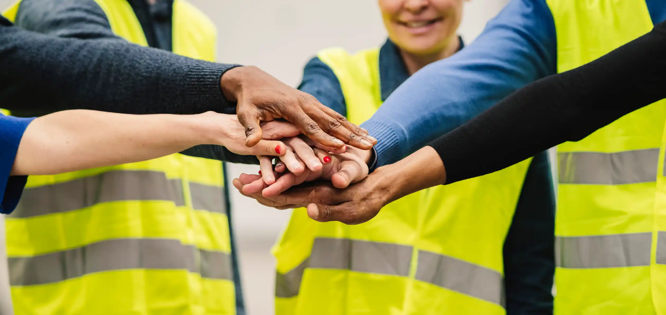 Hands together in a team cheer.