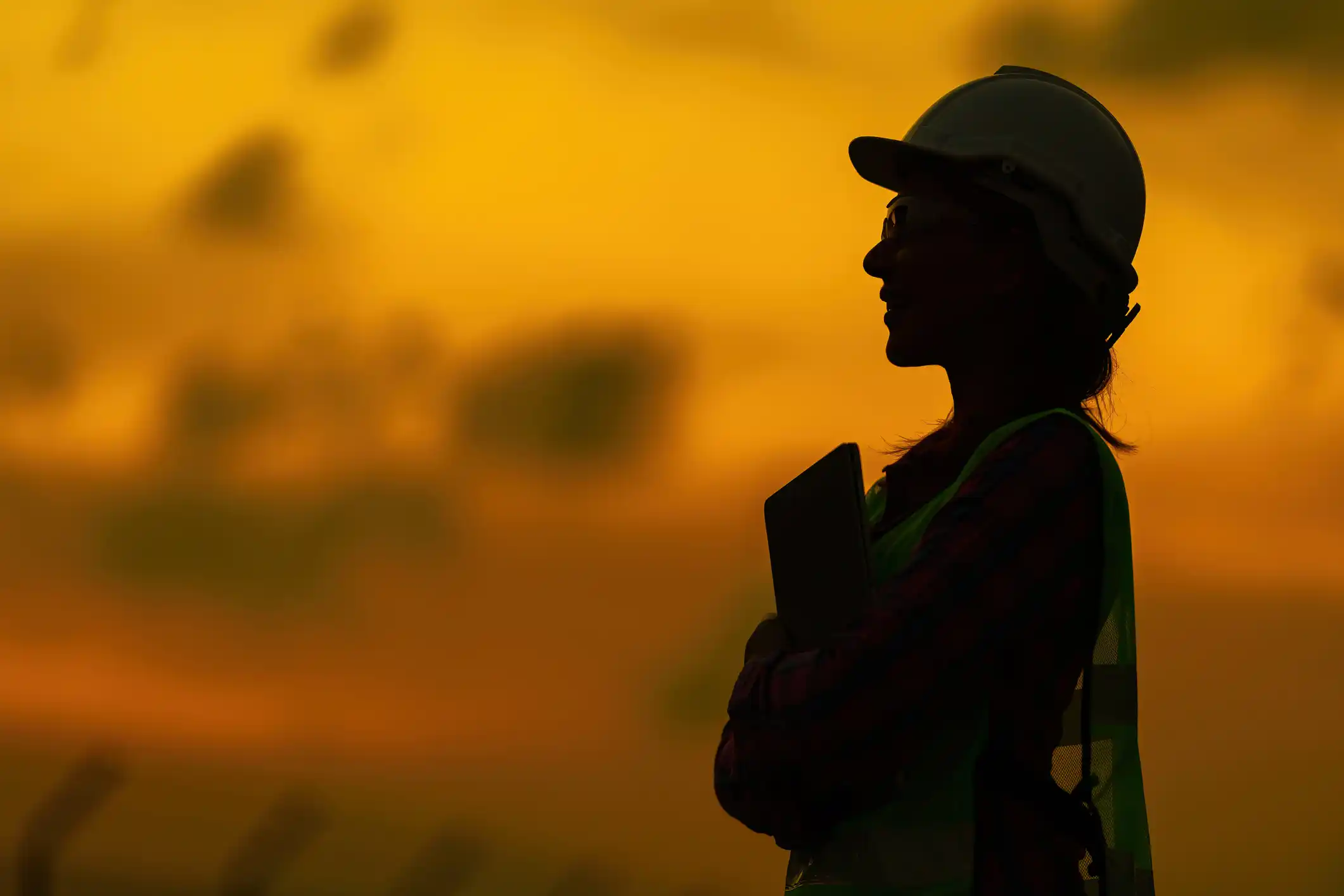 Engineers silhouette against sunset 