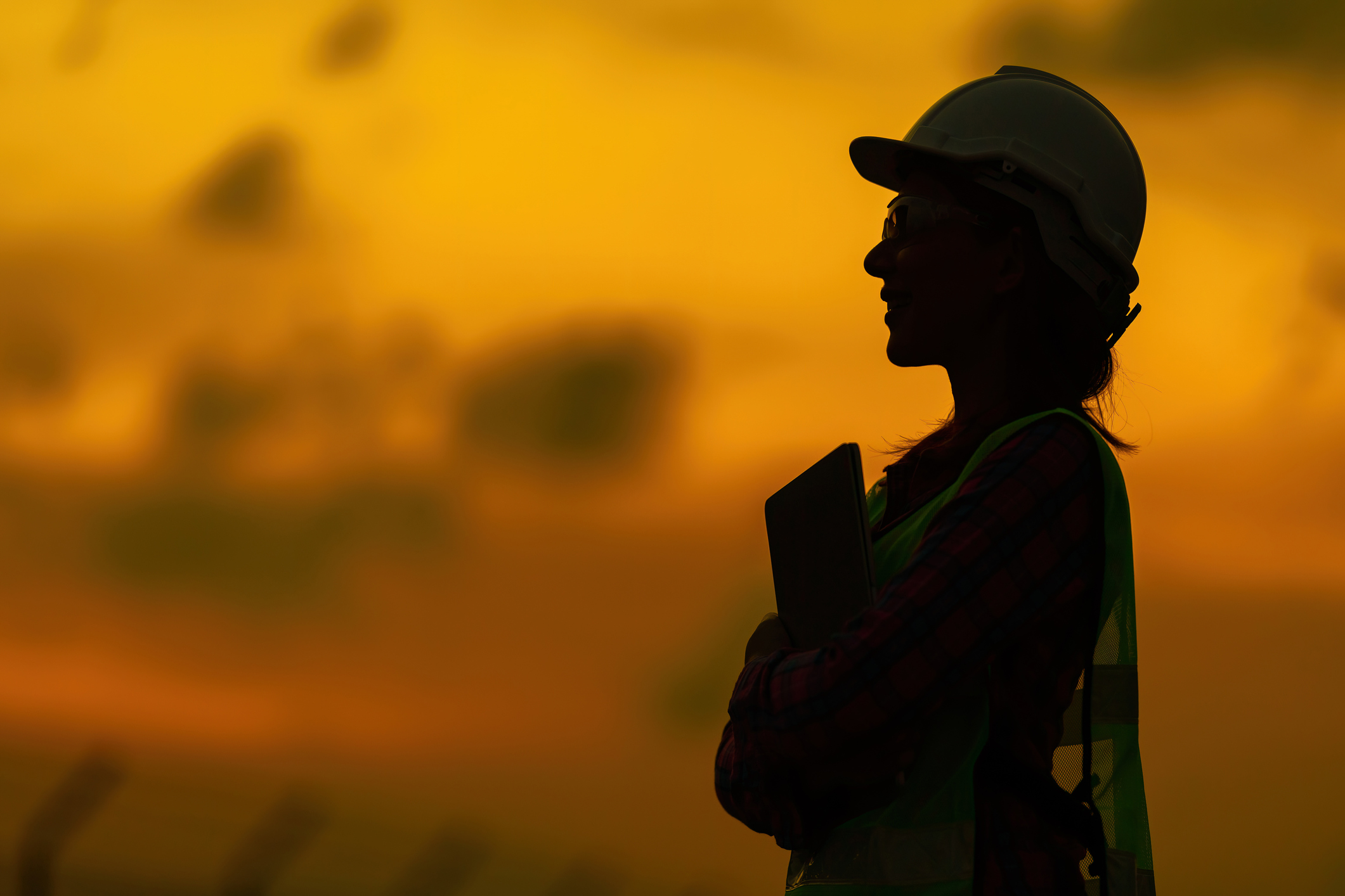 Engineers silhouette against sunset