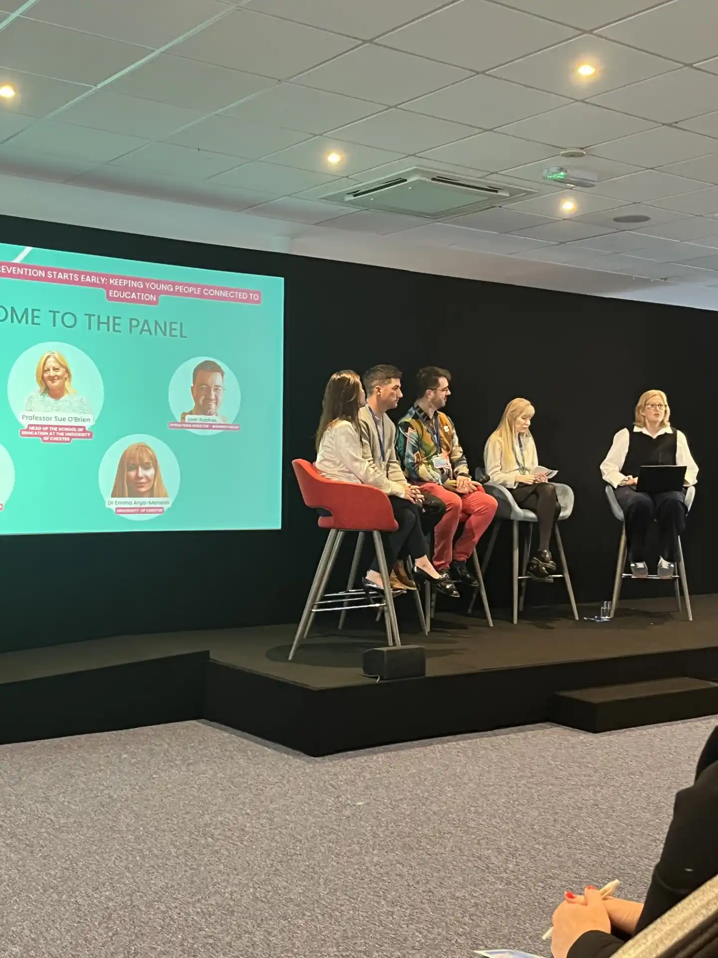 Panel on stage at a conference