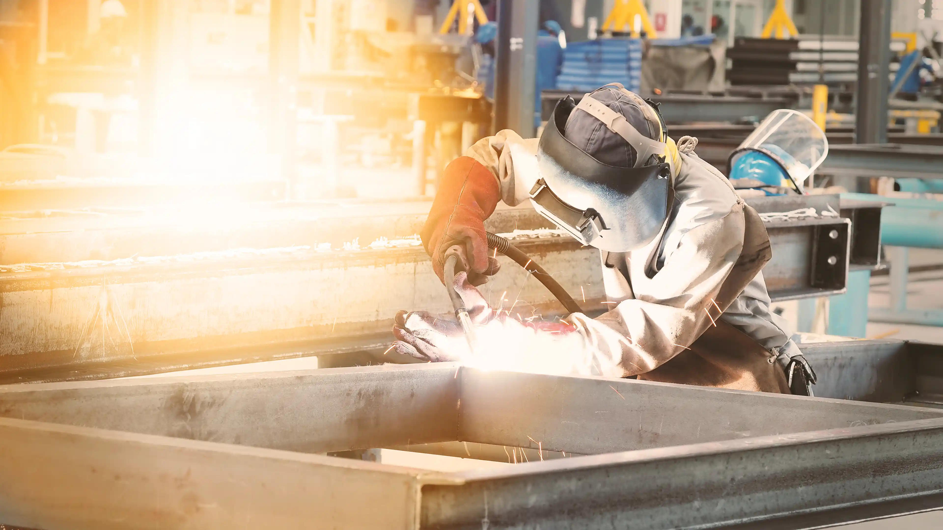 Engineer welding a piece of metal