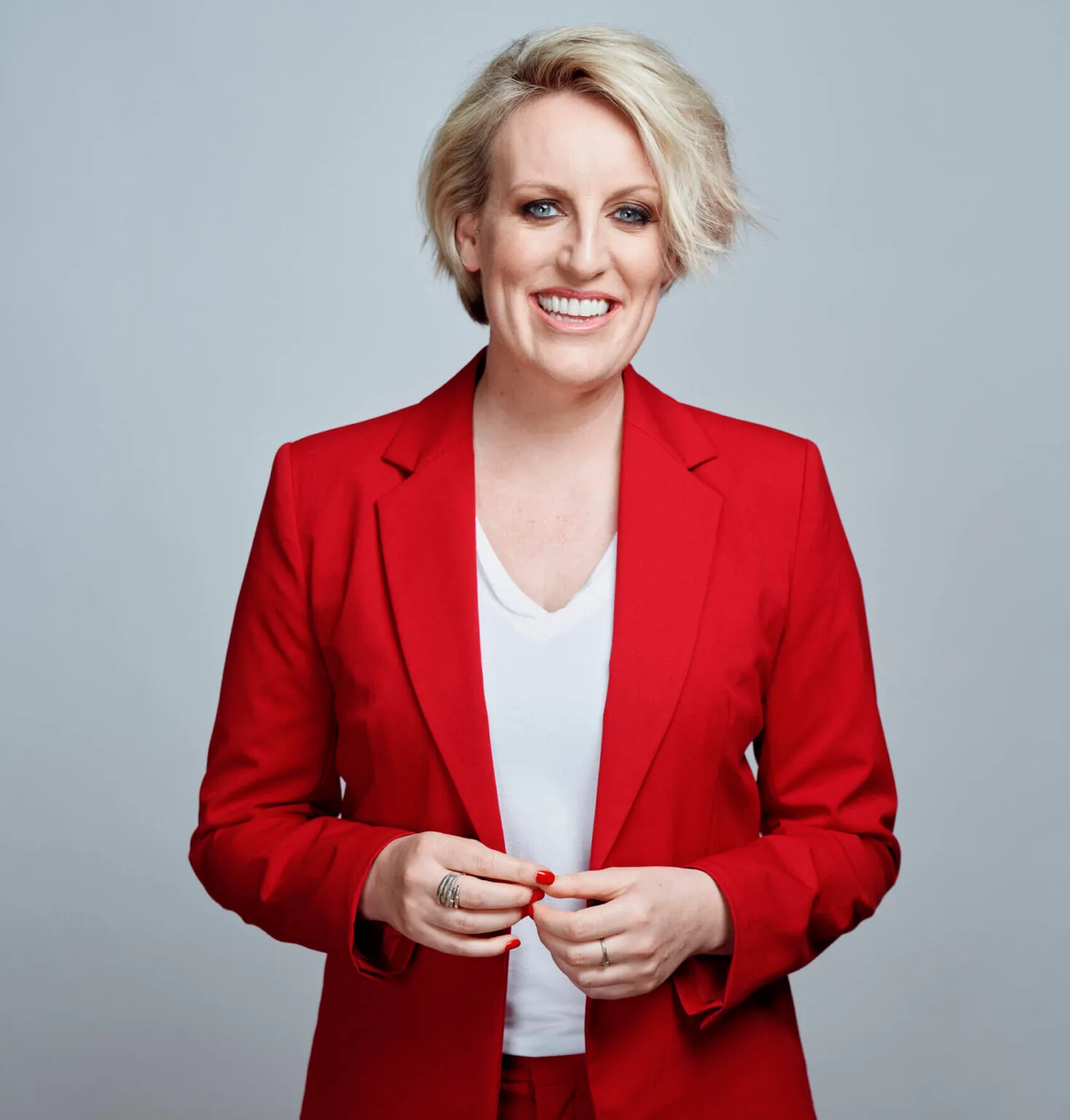 Steph McGovern headshot in red suit and white background