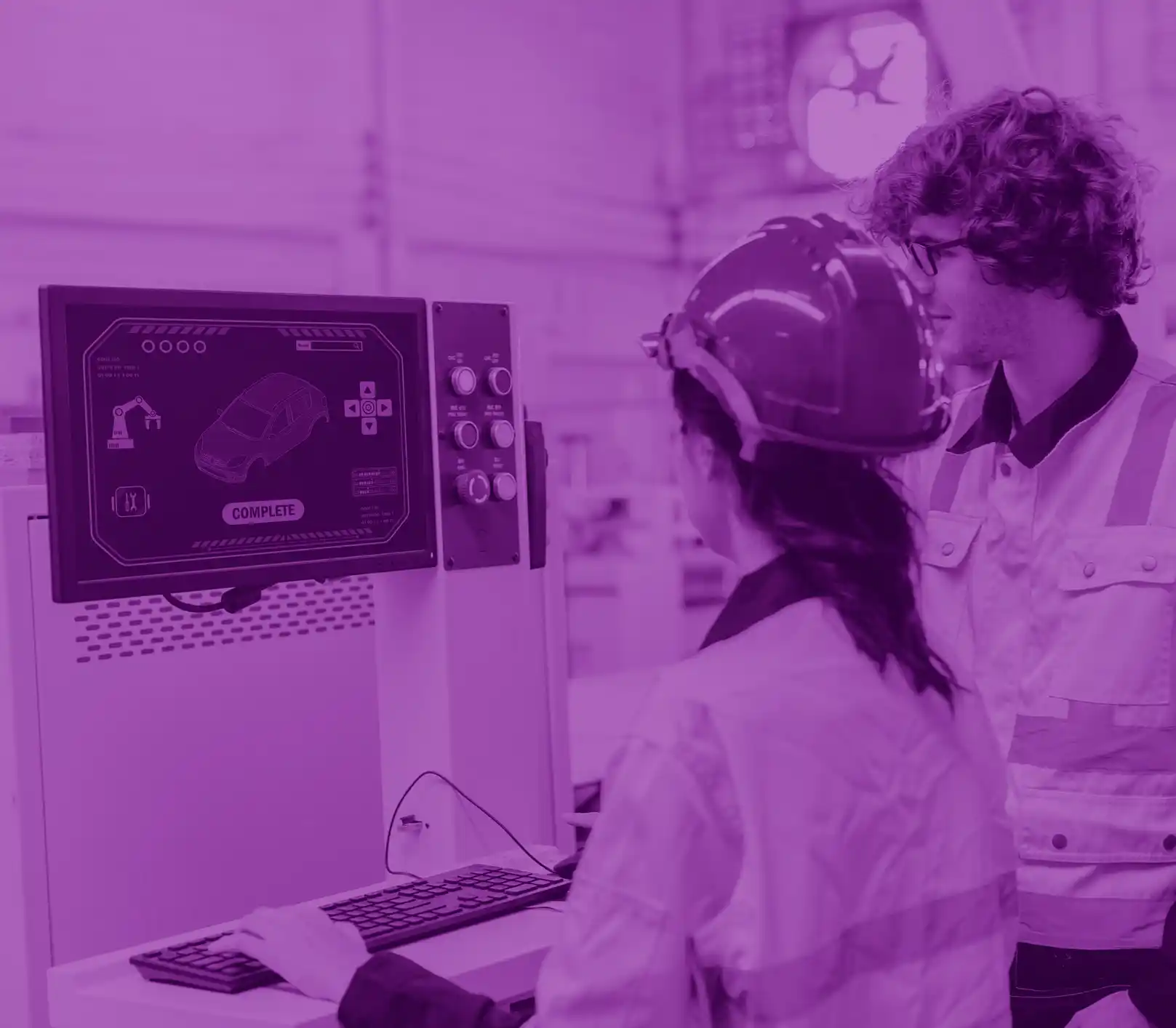 Automotive engineers in a lab, looking at a screen