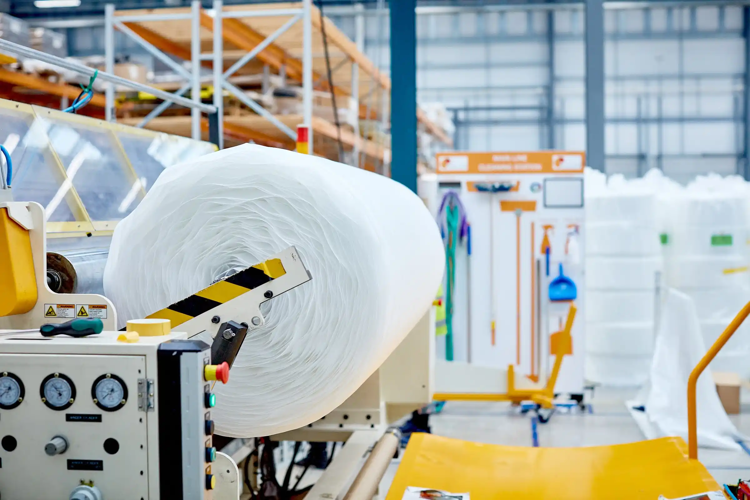 A roll of plastic in a factory.