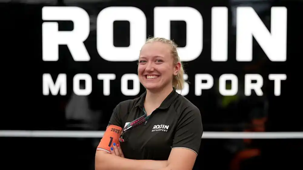 image of Lucy Gould standing in front of a Rodin Motorsport logo