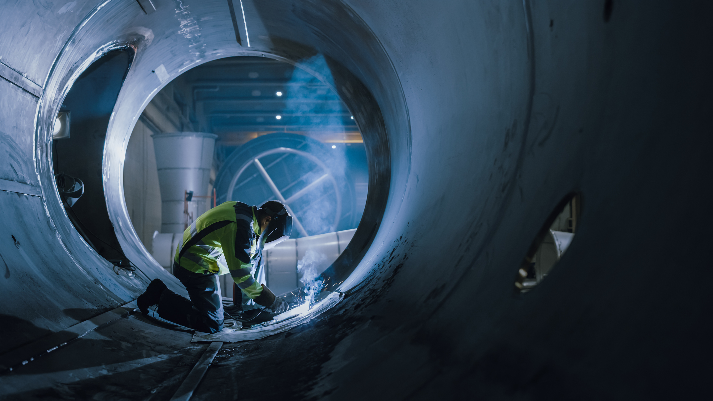 Welder working inside pipe