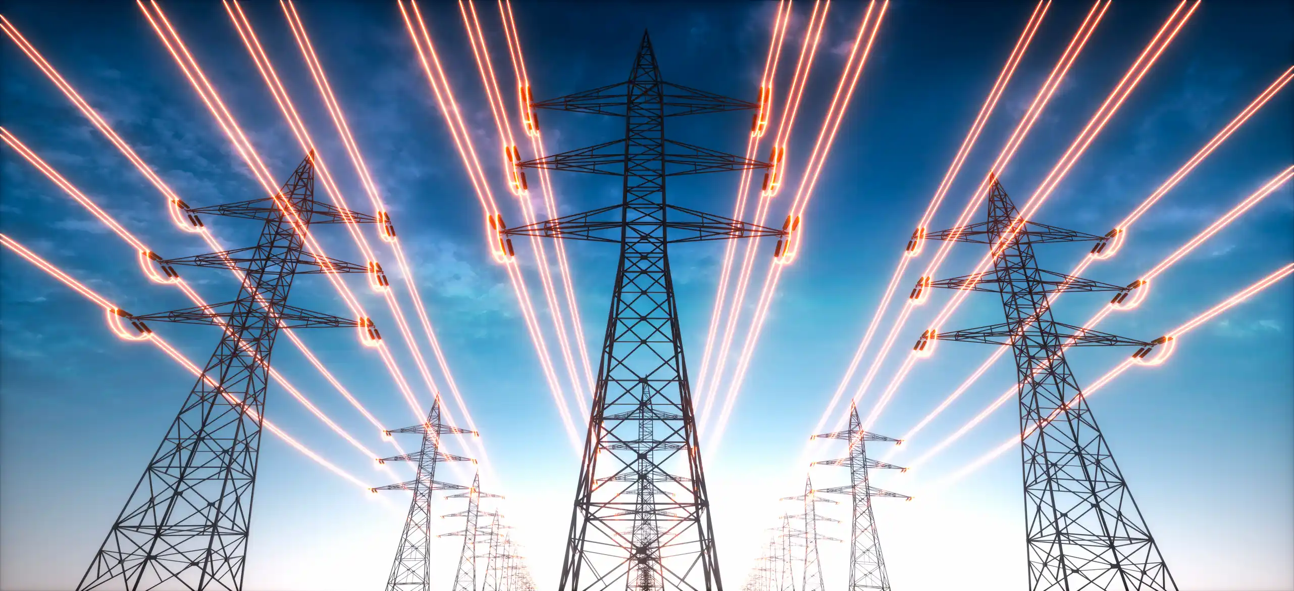 Electricity transmission towers with glowing wires against the sky.