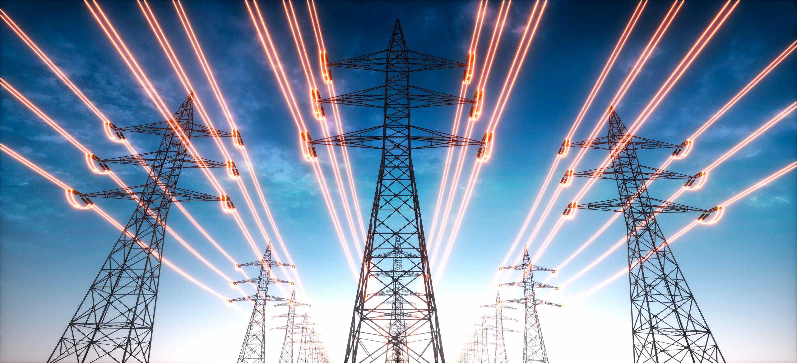 Electricity transmission towers with glowing wires against the sky.