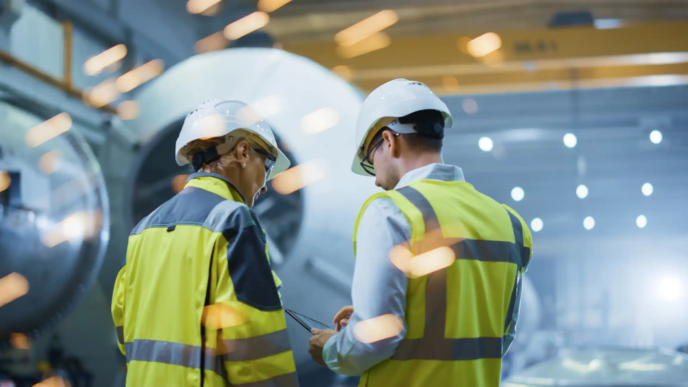 Engineers working together in factory. 