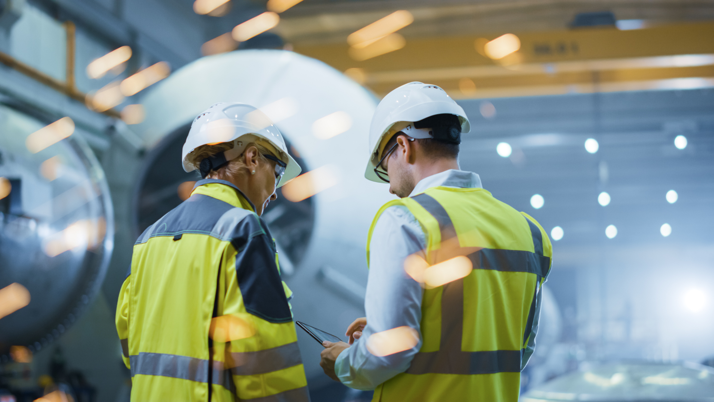 Engineers working together in factory.