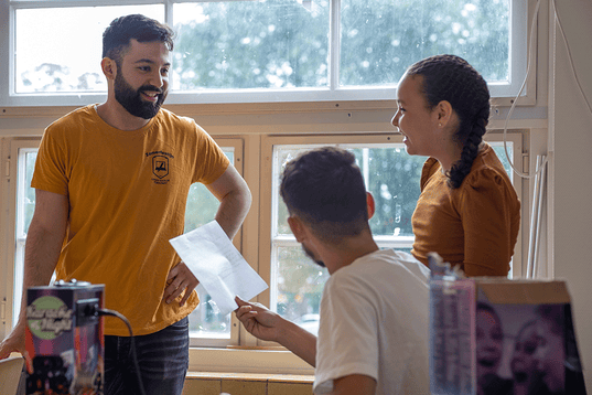 Three people discussing homework