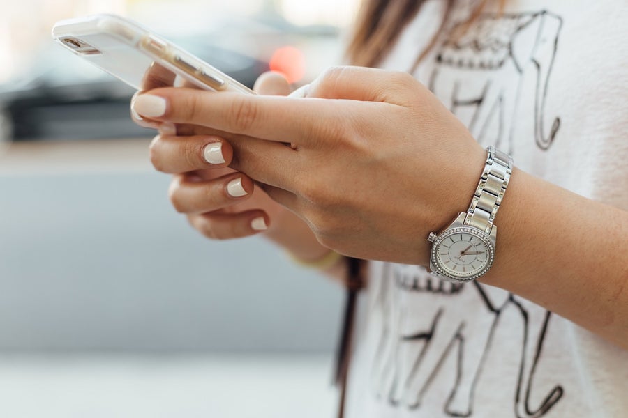 Closeup of someone typing on a smartphone