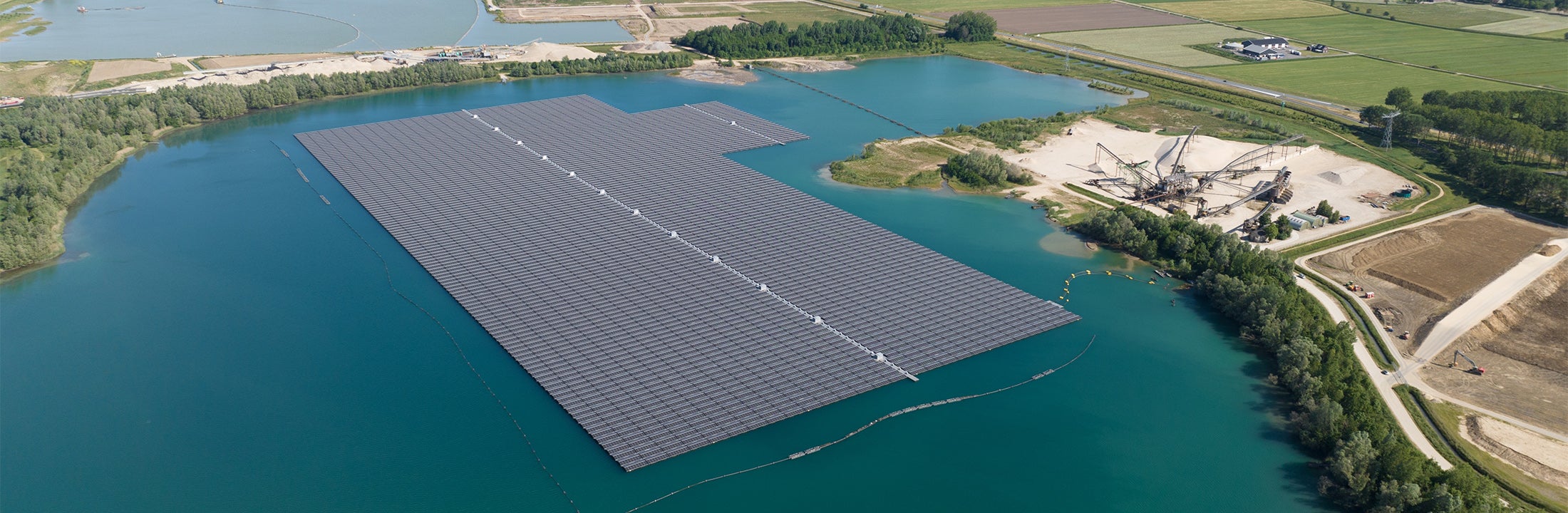 Landschap met infrastructuur, landbouw, weg- en waterbouw en drijvende zonnepanelen.