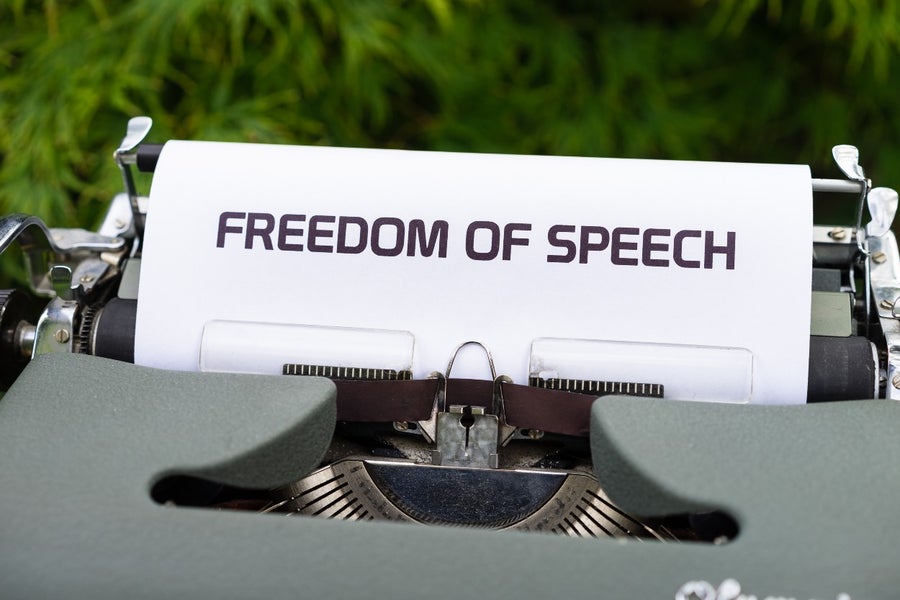 Typewriter holding a paper that says "Freedom of speech"