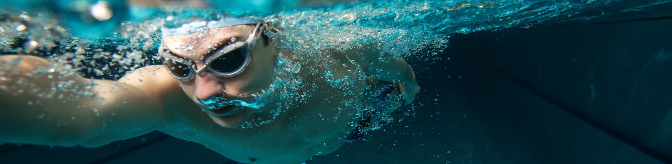 Underwater image of a man wearing swimming goggles