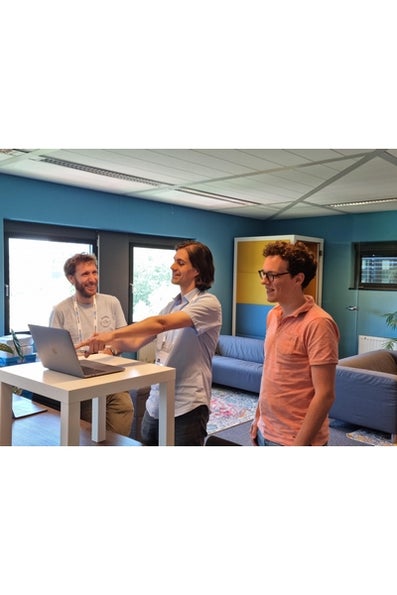 Three men standing around a laptop. 
Source: https://twitter.com/eScienceCenter/status/1539594200764792836